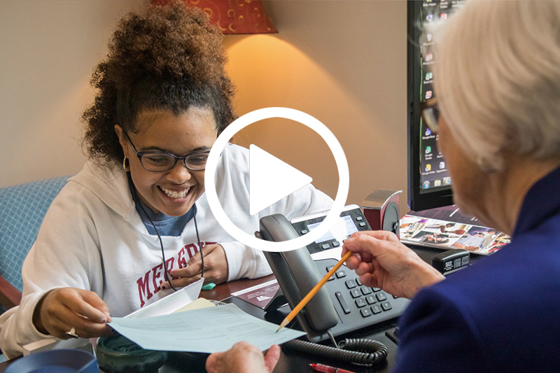 Click Image of Financial Assistance Counselor assisting student to watch video in modal