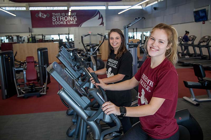 Two students using elliptical machines in Meredith's Lowery Fitness Center