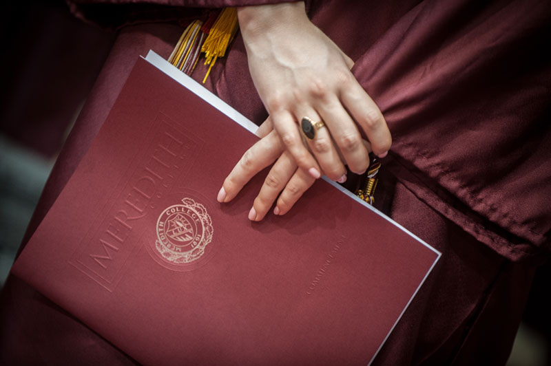 Hands holding diploma