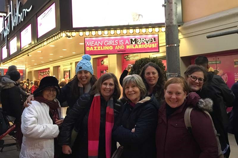 Group photo of alumnae at a broadway show