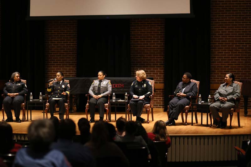 Six women police chiefs on stage at Meredith College
