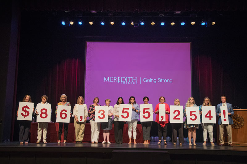 President Allen and Staff members holding signs that show a total of $86,355,254!