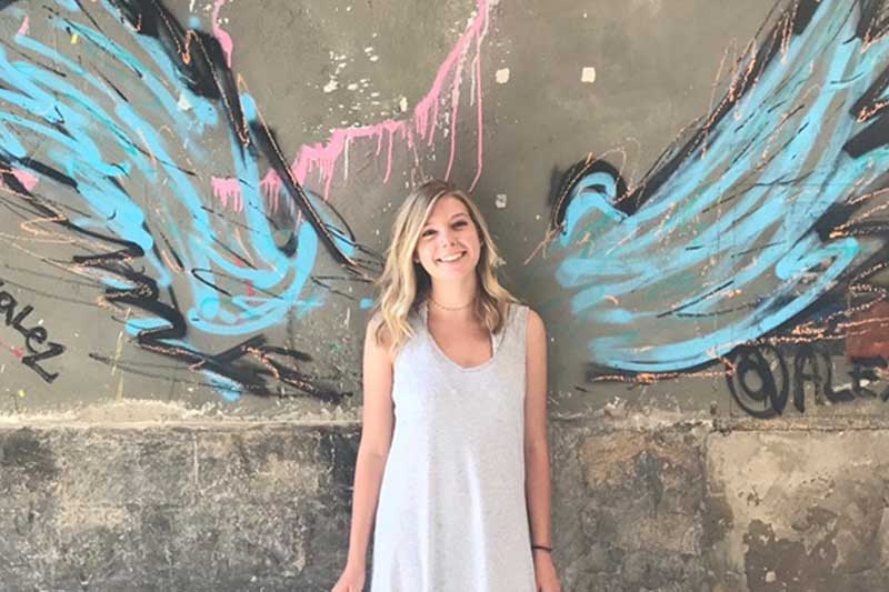 Olivia Holway in front of wings portrait