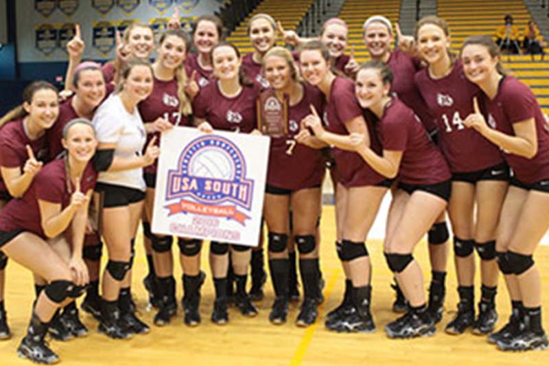 Team photo of Volleyball team with USA South banner