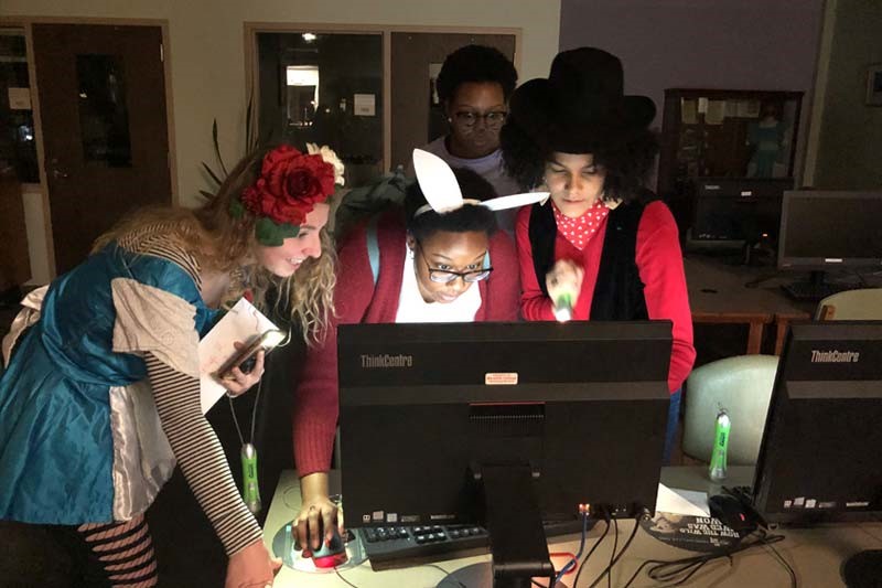 Students work on clues during Library Murder Mystery Night
