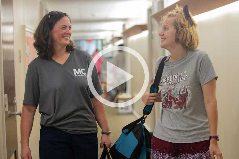 Click on image of students walking in dorm to play video in modal
