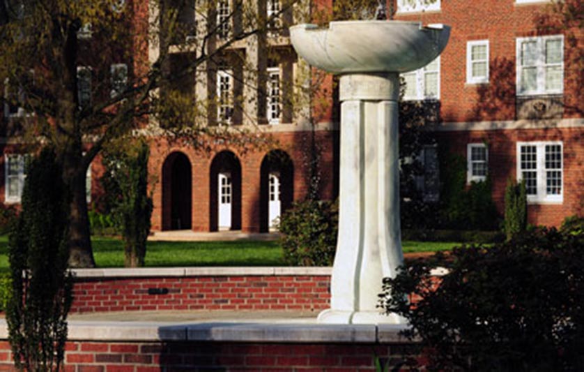 Fountain in Meredith courtyard with a residence hall in the background