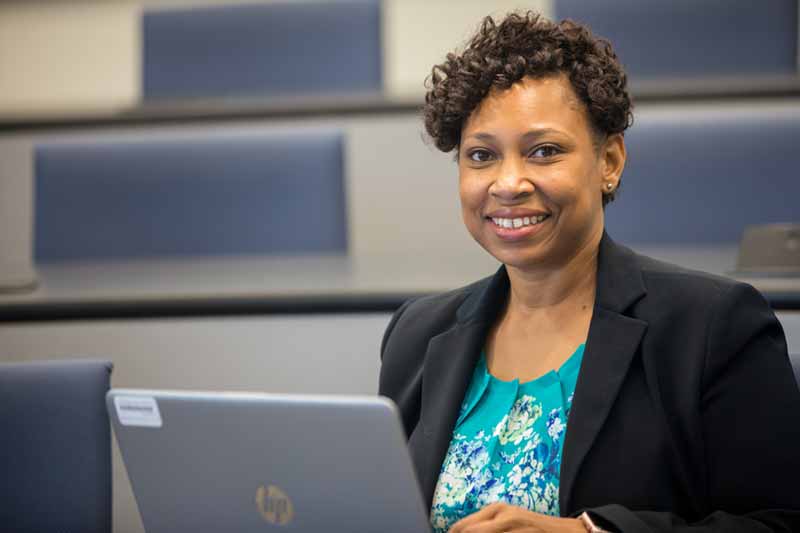 MBA alumna Candance Goins in front of her laptop.