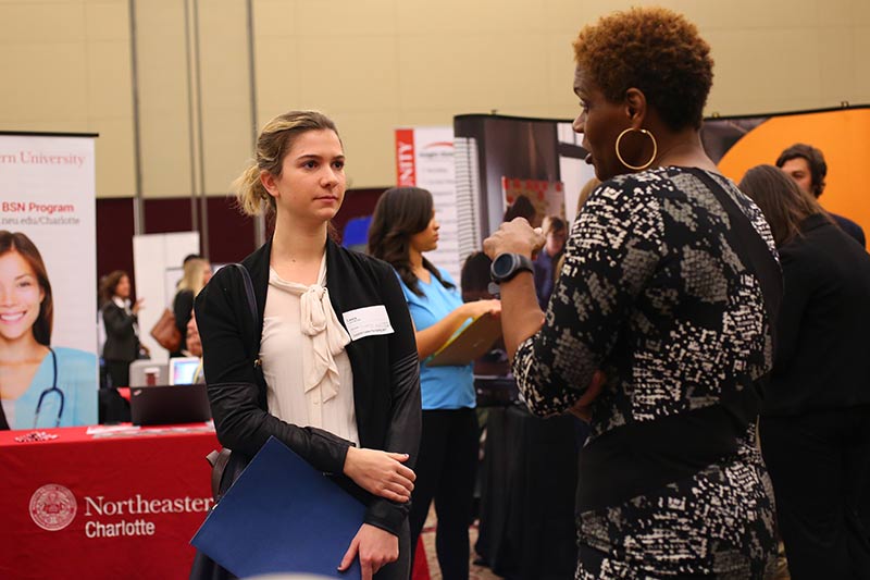 A Meredith student talking to a recruiter at the career fair.