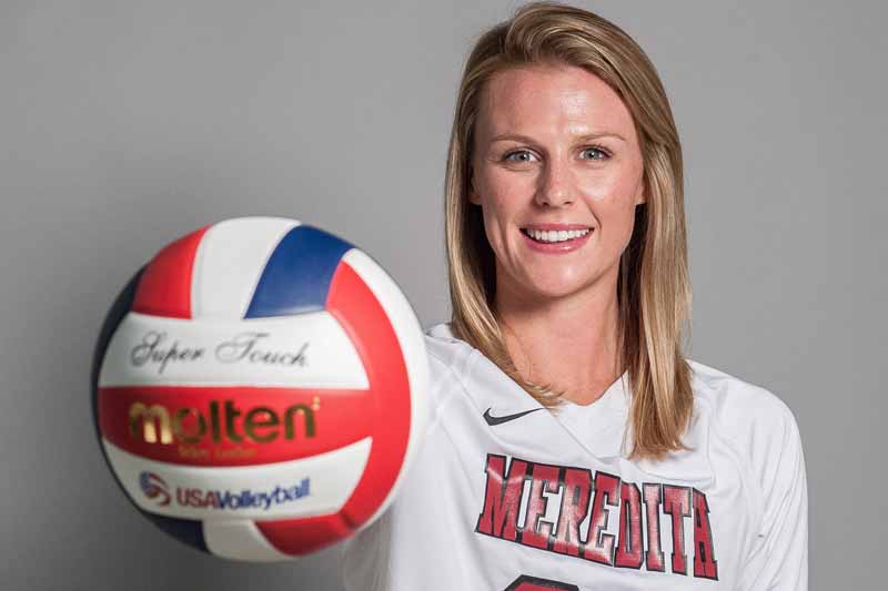 Meredith student-athlete Caroline Corey holding a volleyball