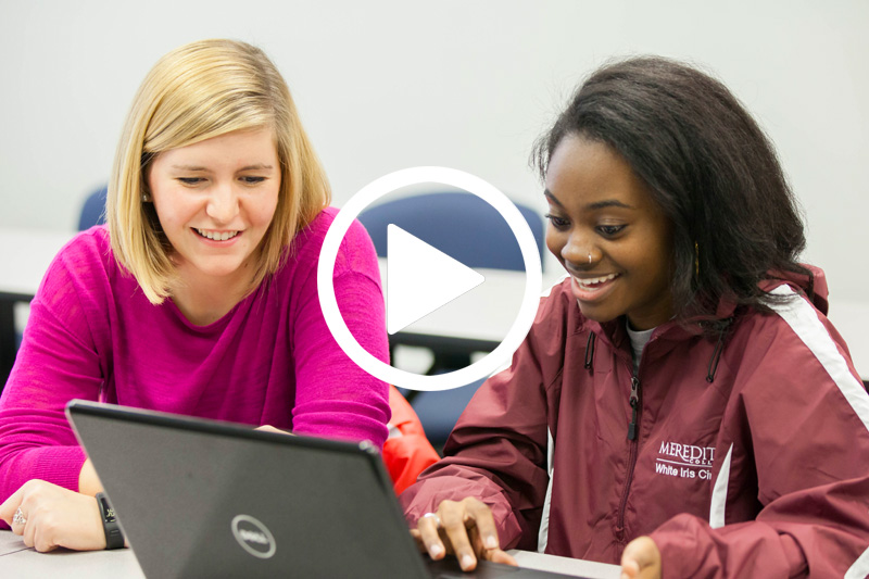 Click image of students looking at laptop screen to watch video of donors Cooper & Ann Lowery in modal