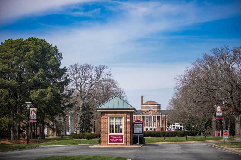 Guard House on main campus drive with Johnson Hall visible in the distance