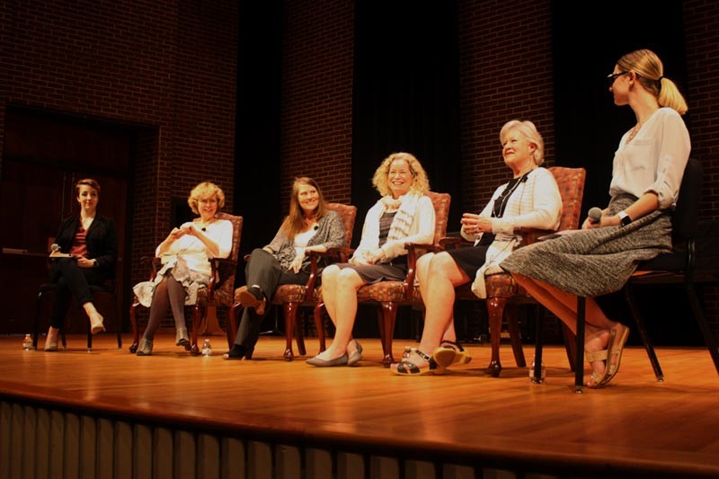 Panelists on stage during a discussion on social inequality