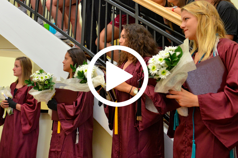 Click image of students in commencement gowns to watch Lacrosse Graduation Ceremony video in modal