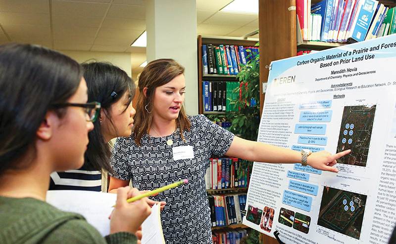 students in front of poster presentation