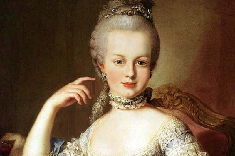 Painting of Marie Antoinette sitting in a chair wearing a white dress