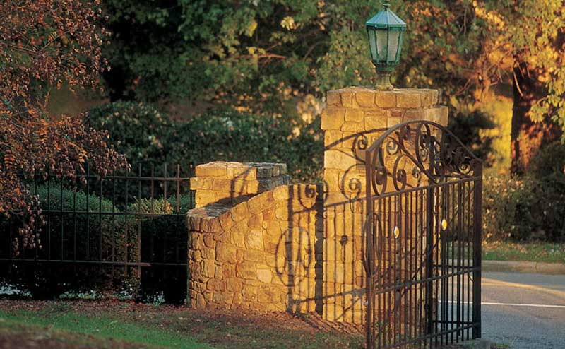 Meredith College back gate, which has stone columns and an iron gate