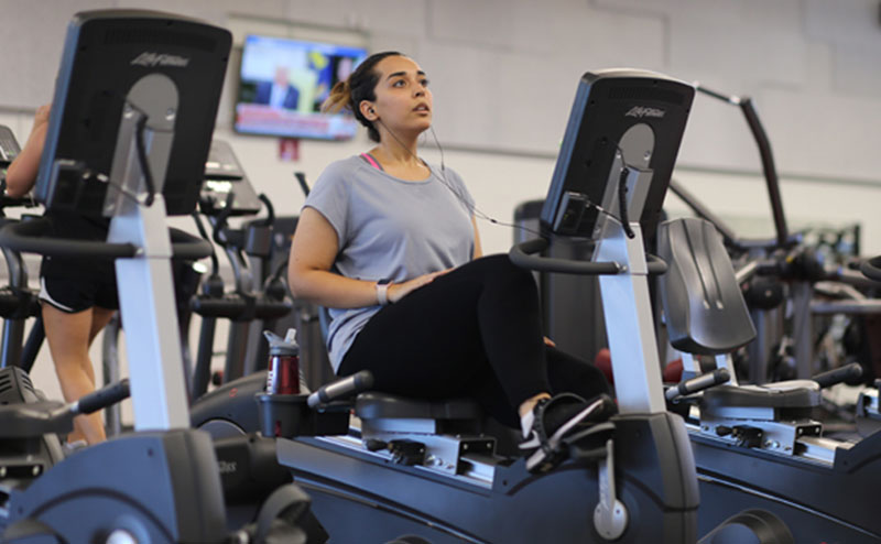 Student uses stationary bike in Meredith fitness center