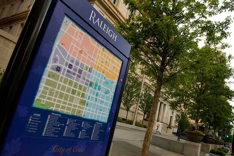 A blue kiosk with a map of downtown Raleigh