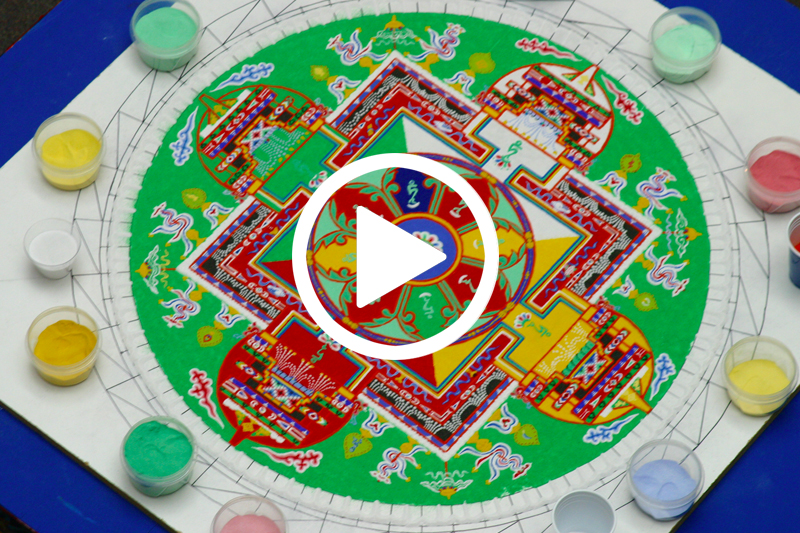 Click on image of mandala image containing green yellow and blue colors to watch Sand Mandala Timelapse video in modal
