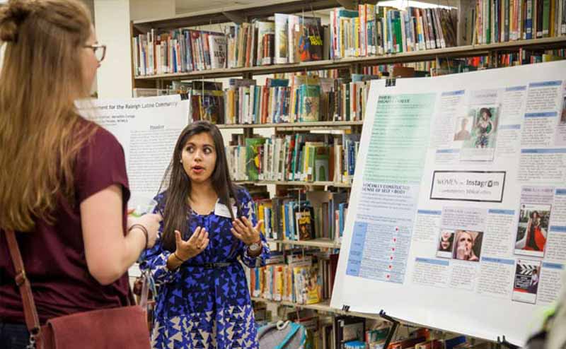 Student Presenting Project in Library