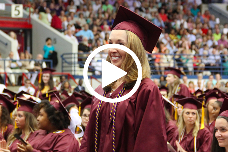 Click on image of female graduate at commencement to watch Wings Program Video in Modal