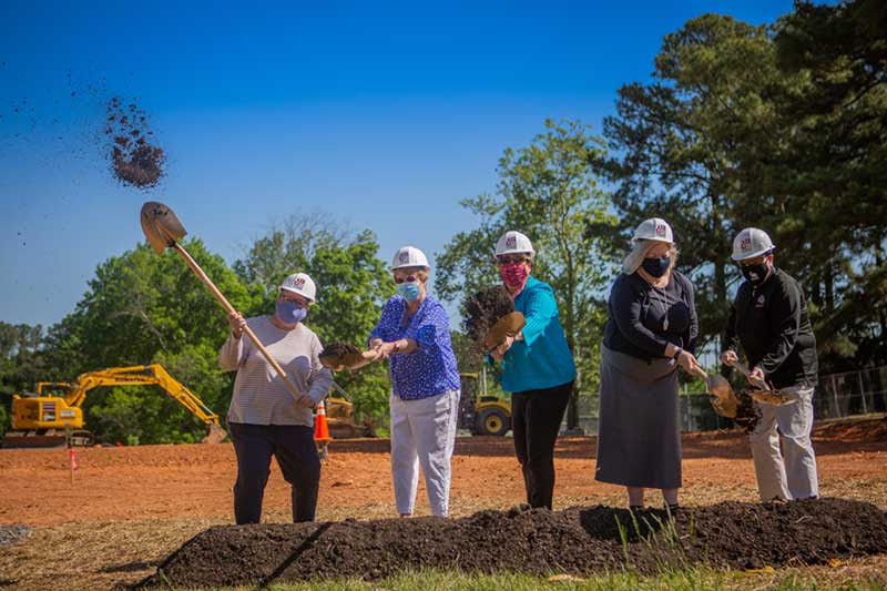 Five Meredith administrators with shovels