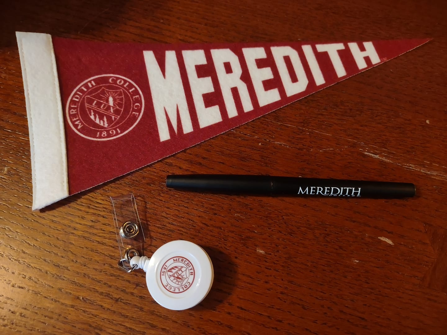 Teacher gifts including pennant, pen, and badge holder
