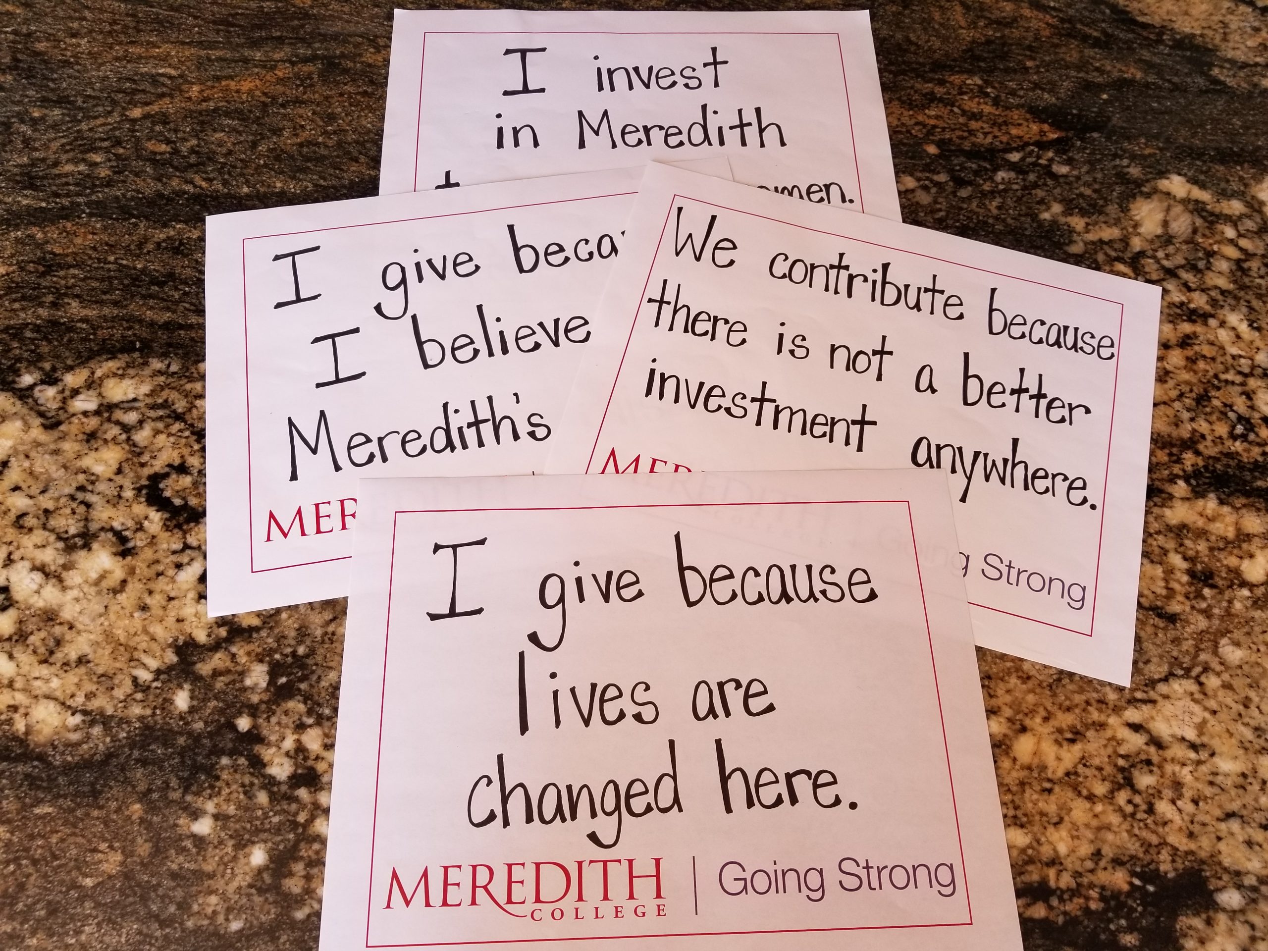 Signs with messages about why donors give to Meredith