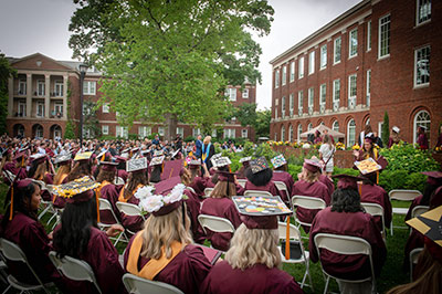 Meredith graduates seated in courtyard for Commencement.