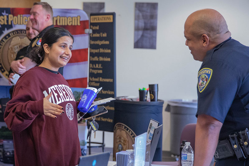 A Meredith student talks with an officer.
