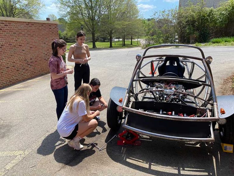 Students working on EV Car