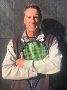 Eric Douglass holding a tennis racket.