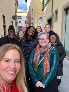 Nine faculty and staff pose for a selfie in the streets of Sansepolcro.