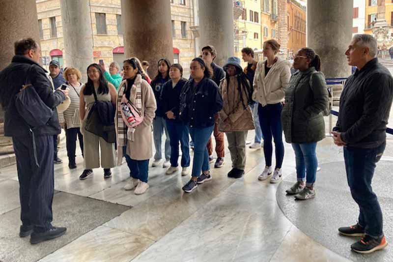 Students on a tour of an old building in Italy.