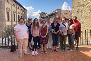 Spring 2023 faculty staff members smile from the top of the art museum in Sansepolcro.