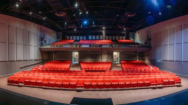Jones Auditorium interior with old red chairs.