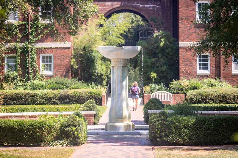 The ɫҹ fountain and a student walking to class in the background.