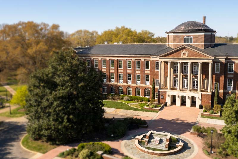 Aerial view of Johnson Hall and fountain during spring.