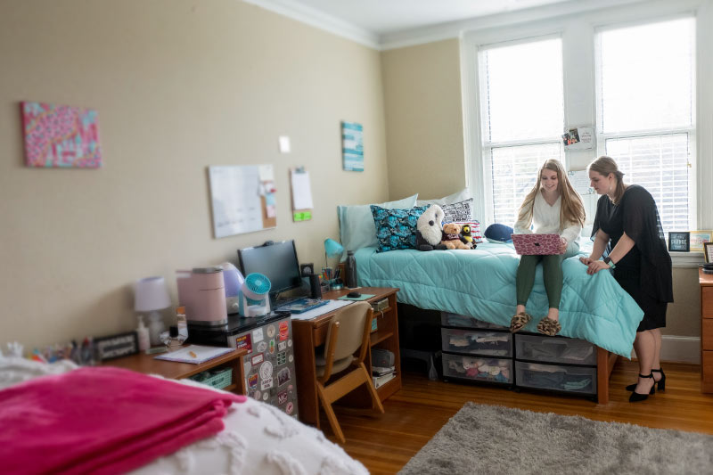 Two students in their residence hall room.