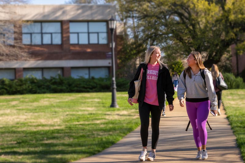 Two students walking on Meredith's campus
