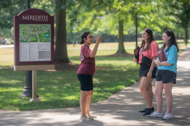 Two prospective students on a campus tour given by a Meredith student.