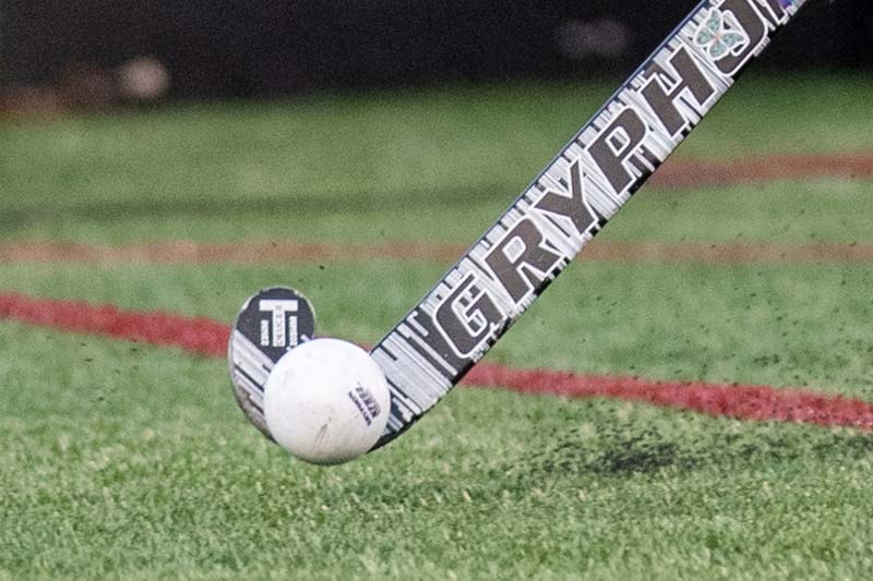 Picture of Field Hockey Stick and Ball on Turf Field.