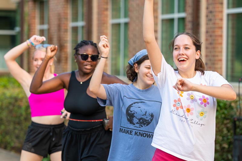 Four Students Dancing at MC Block Party