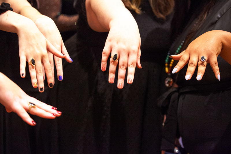 Four students showing off class rings at Ring Ceremony Dinner.