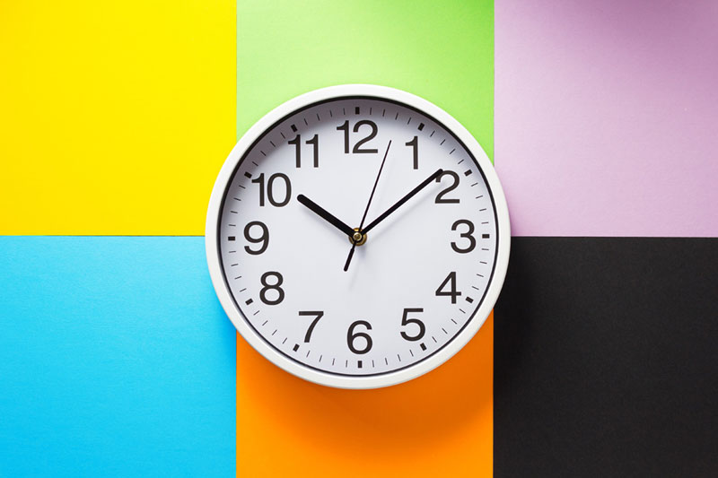 Clock on Yellow, Green, Pink, Blue, Orange and Black Wall.